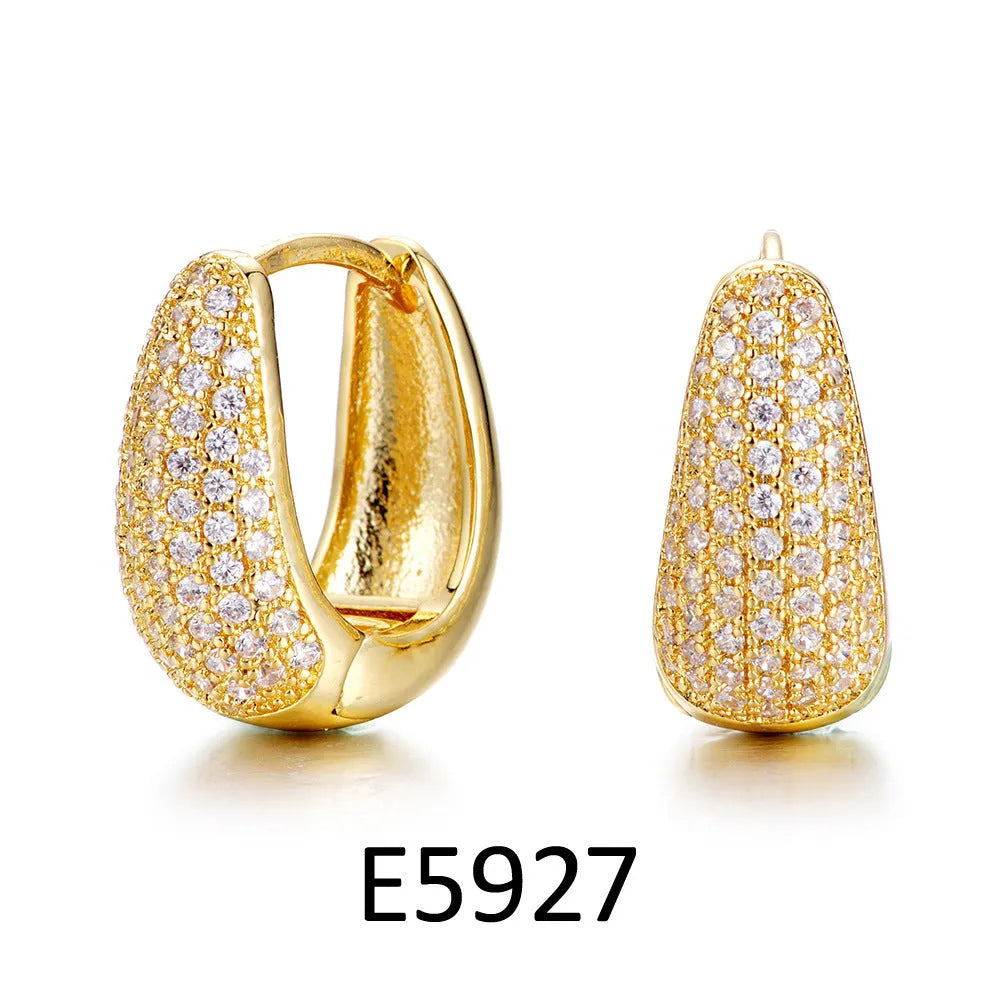 Brass gold plated heart shape clip-on earrings with gang drill detailing on a copper base.