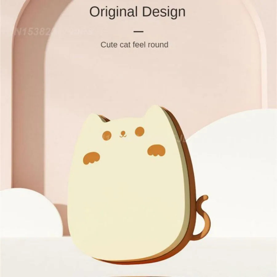 Brown sponge silicone pet hair removal brush with comb teeth on a wooden surface