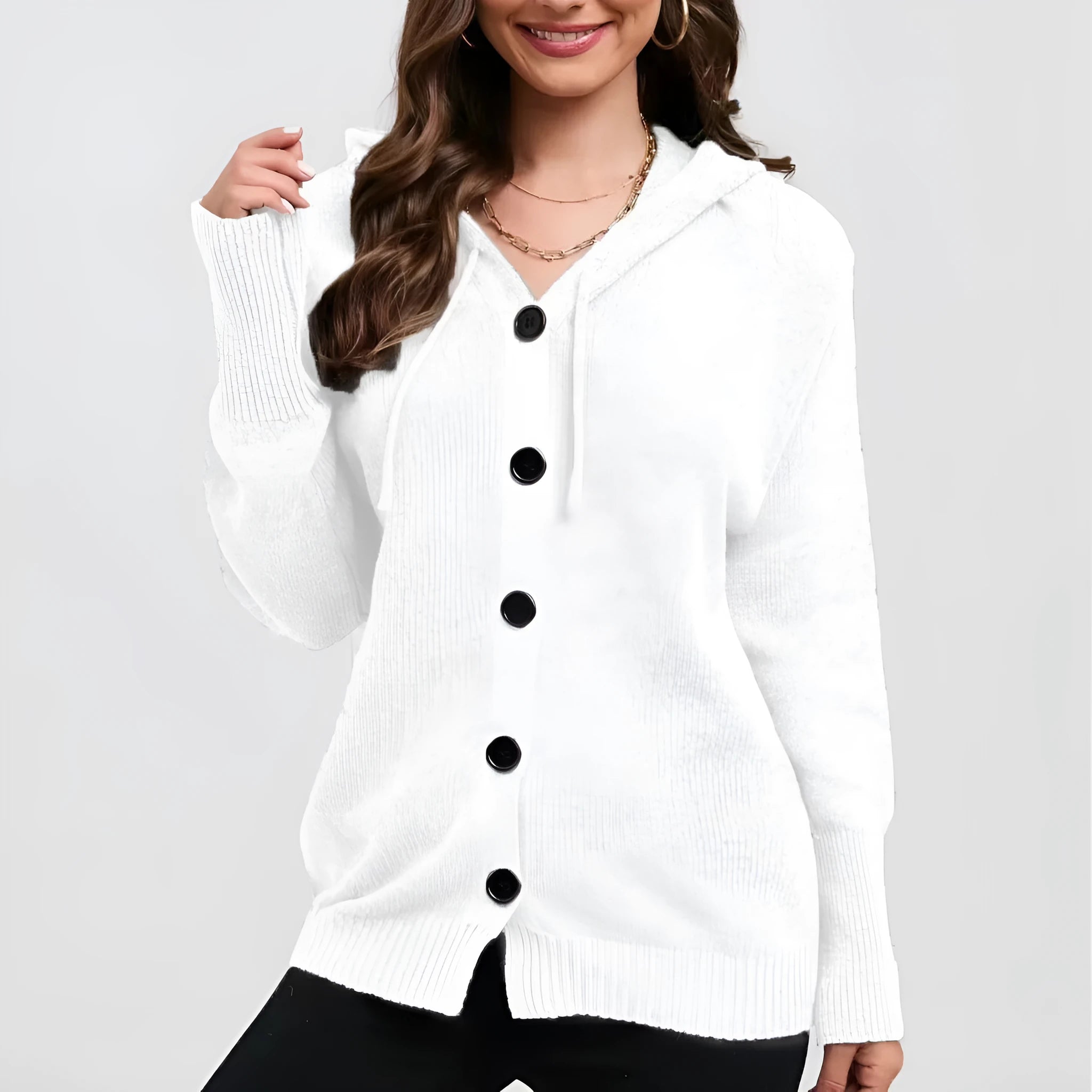 A woman wearing a loose-fit, solid-colour hooded cotton cardigan sweater.