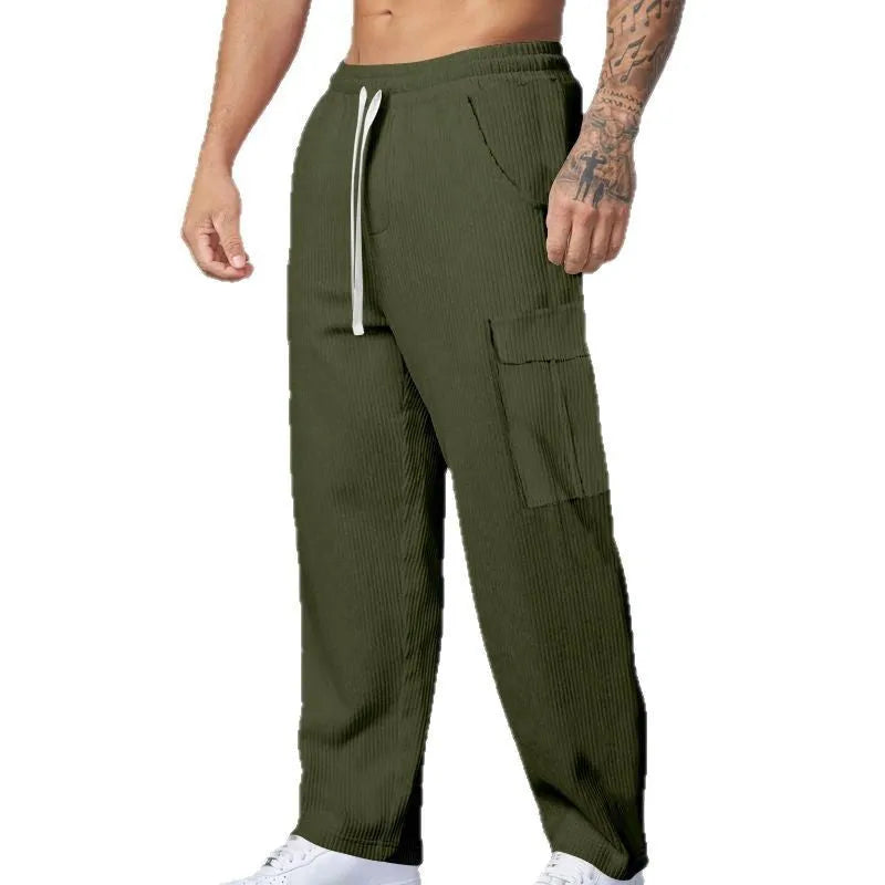 Men's navy blue corduroy cargo trousers with loose fit and straight legs on a hanger.