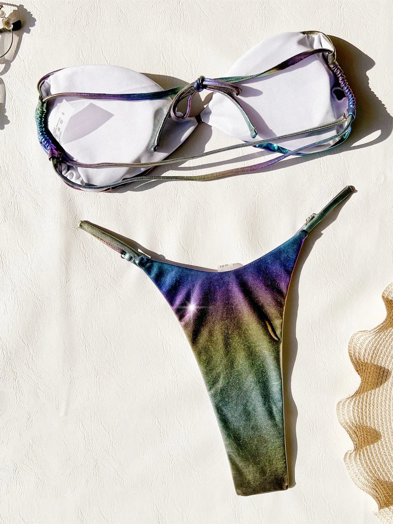 Women's gradient purple bikini swimsuit laid flat, showing top and bottom.