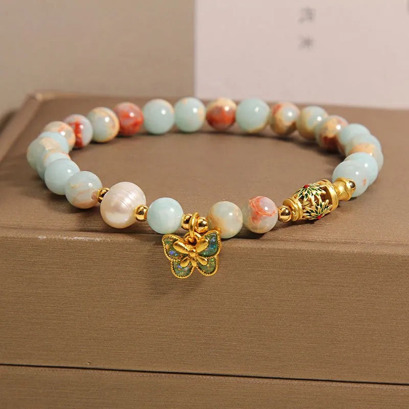 Blue freshwater pearl bracelet with Shoushan stone elements and butterfly pendant.