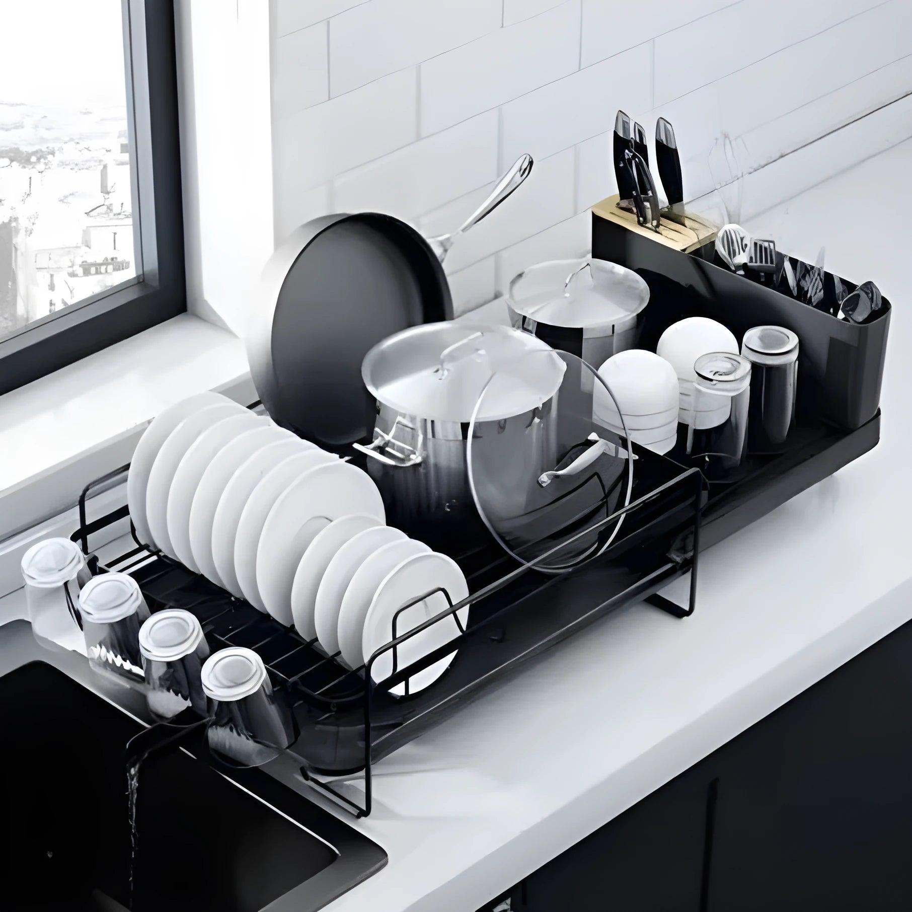 Modern foldable carbon steel dish drain rack for cutlery and cups on a wall.