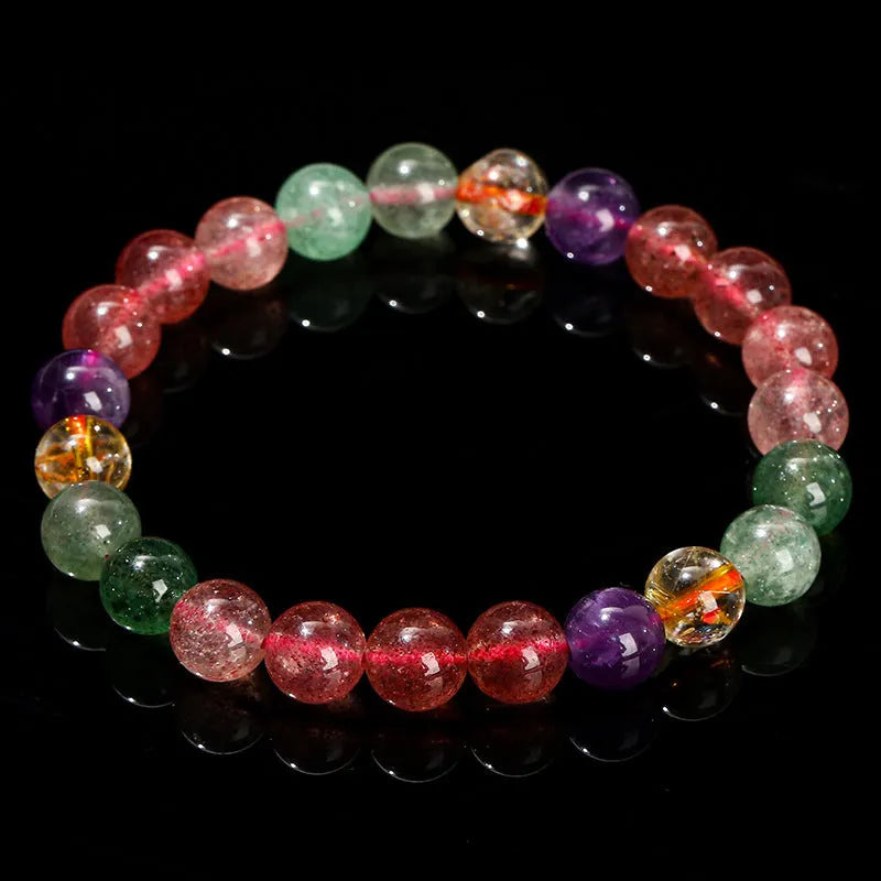 Natural tourmaline colour strawberry quartz bracelet with geometric round beads on a wrist.