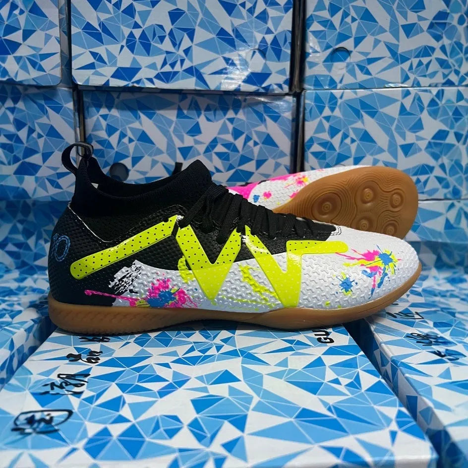 Black and yellow low-top football boots with removable studs on a non-slip rubber sole.