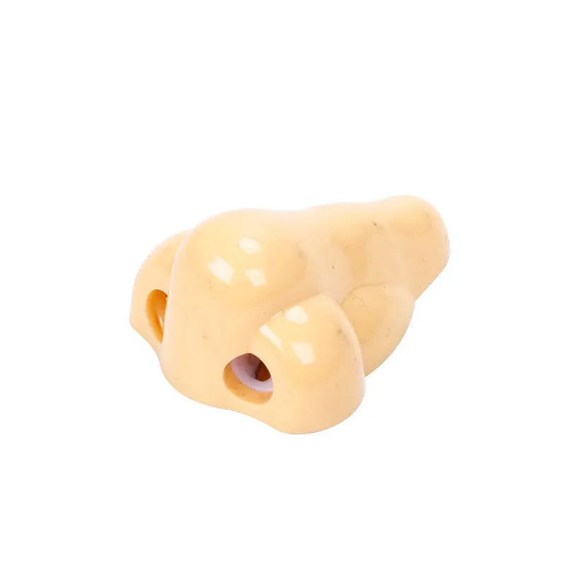 Flesh colour plastic manual pencil sharpener with big nostril and geometry shape.