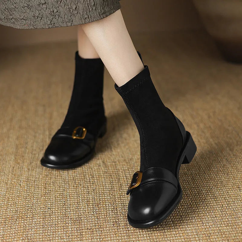 Women's black casual martin boots with belt buckle stitching, lace-up front, and a low rubber sole.
