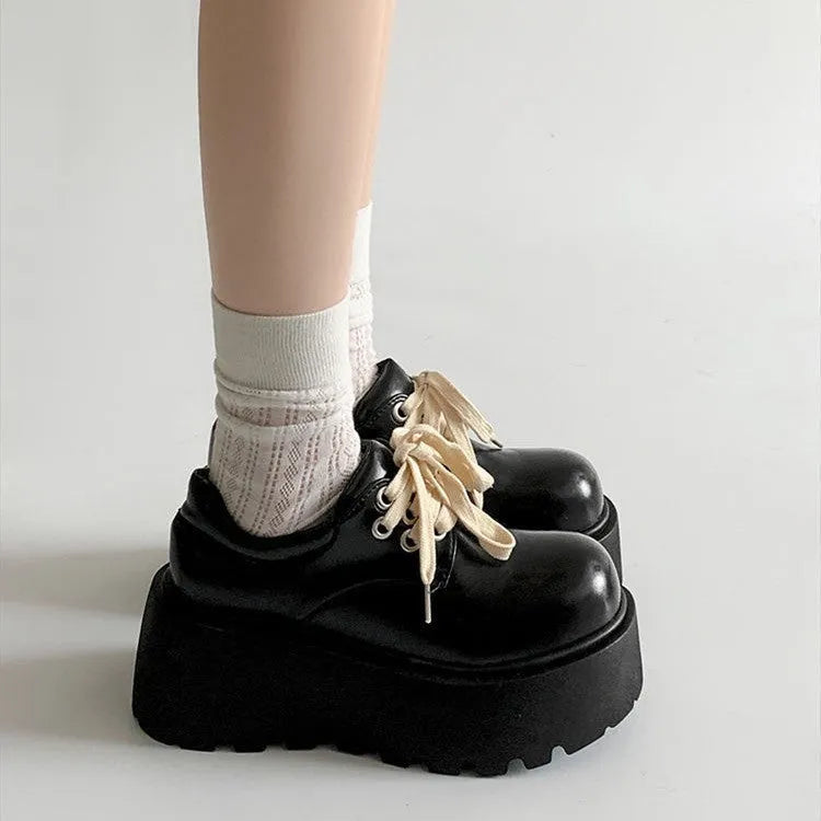 Women's black matte PU leather chunky platform shoes with lace-up buckle and round toe.