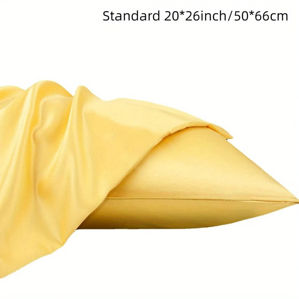A pair of solid colour satin cloth pillowcases made from polyester plain weave fabric.