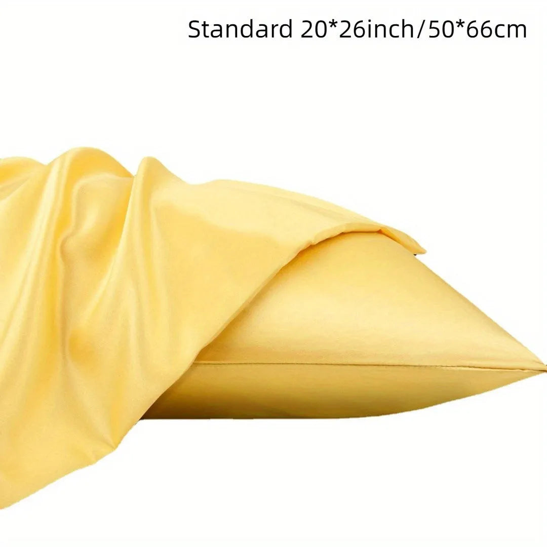 A pair of solid colour satin cloth pillowcases made from polyester plain weave fabric.