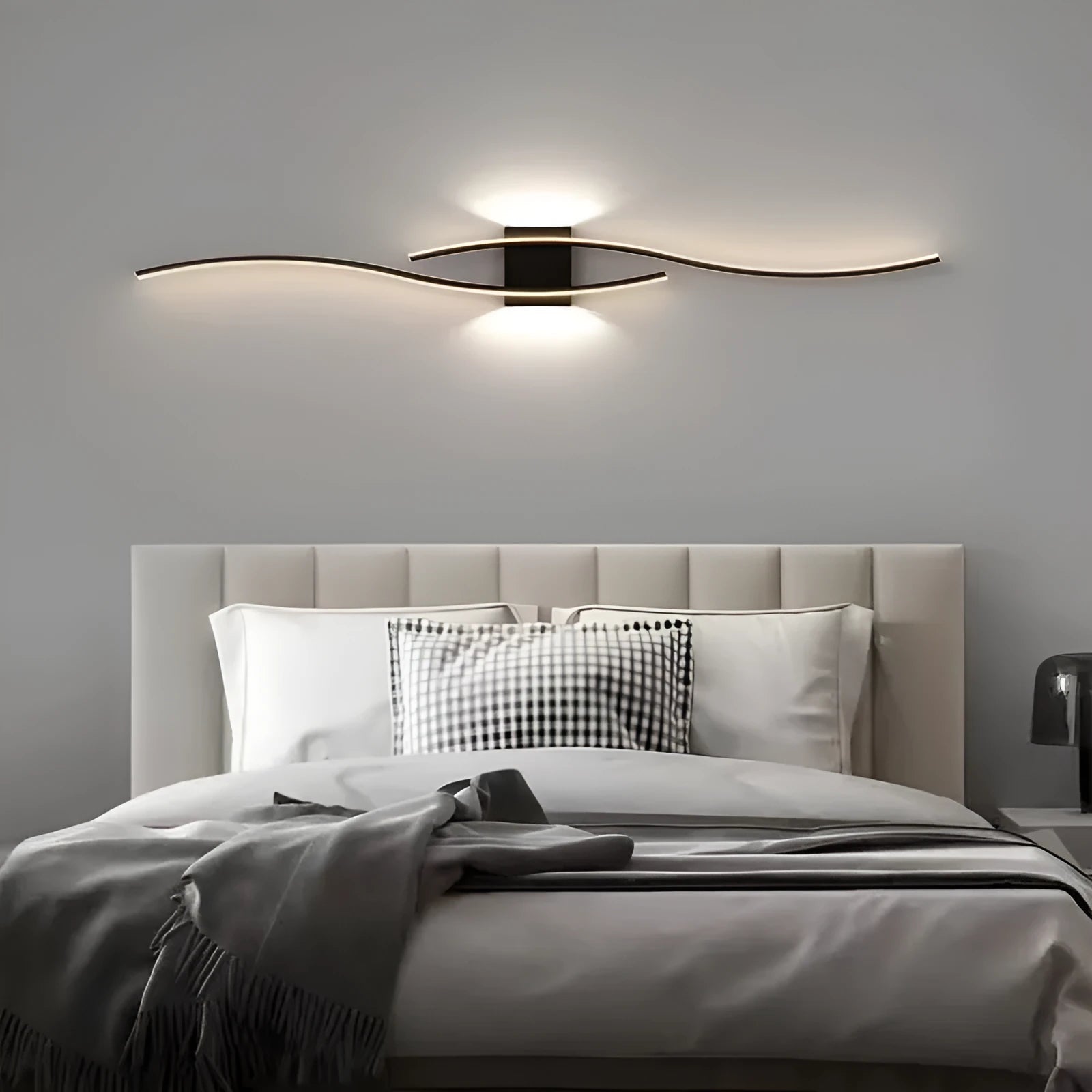 Black 60cm bedside wall lamp with acrylic panel and wrought iron frame on neutral wall
