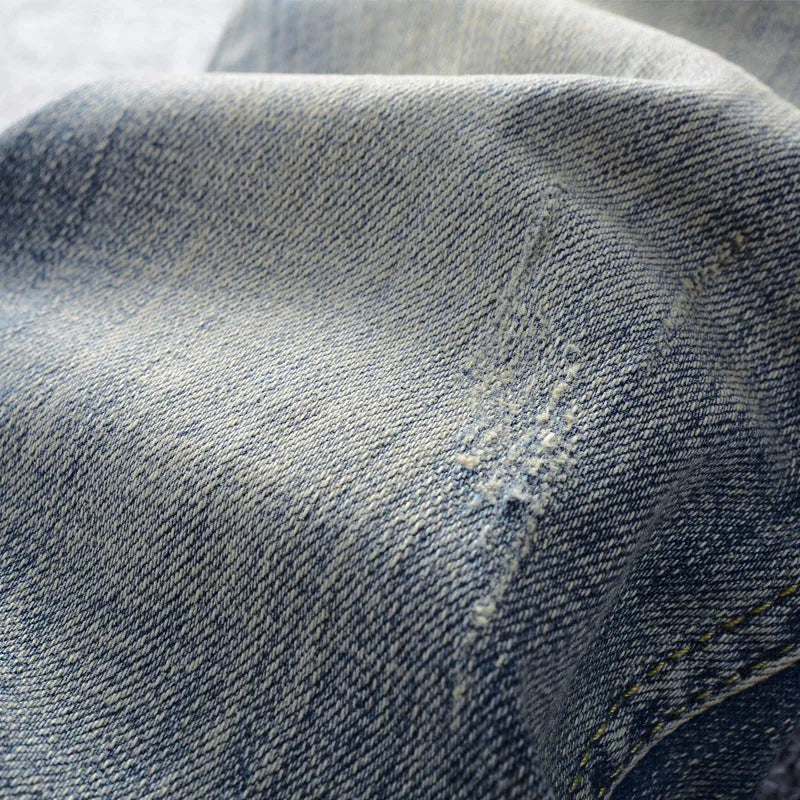 Men's retro straight-leg jeans in distressed blue washed denim with mid waist, zip fly and multiple pockets