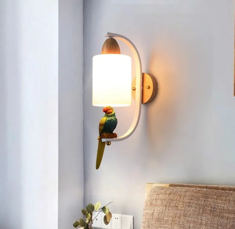 Resin bird wall lamp with iron body, wood accent, and glass lampshade on a wall