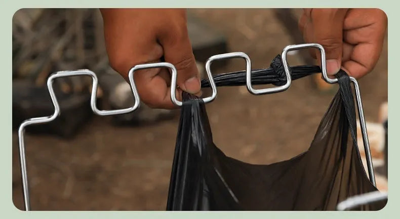Silver stainless steel folding garbage bag bracket holding black bin bag for outdoor use