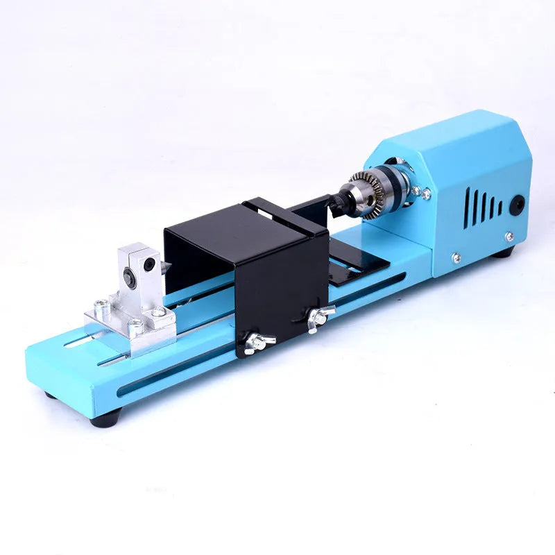 Blue mini DIY woodworking lathe with protective cover on desktop, 150W motor, steel chuck, and accessories
