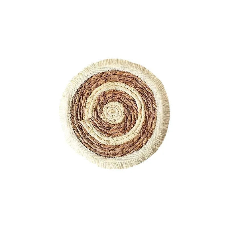 Round Japanese straw placemat with tassel edge in natural papyrus material on wooden dining table