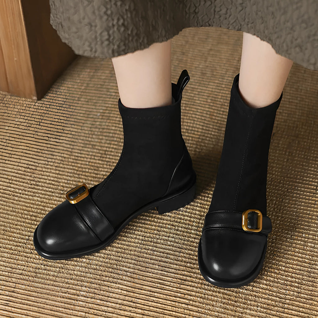 Women's black casual martin boots with belt buckle stitching, lace-up front, and a low rubber sole.