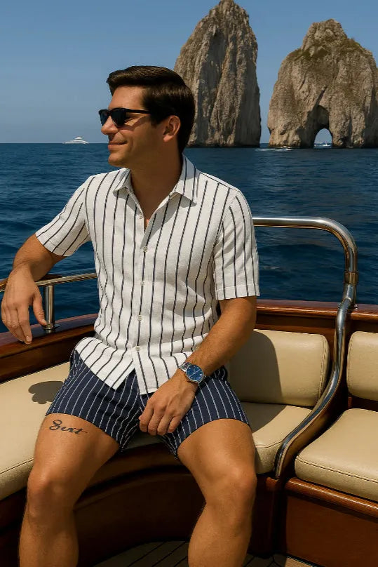 Men's light blue elastic beach shirt and shorts set laid flat.