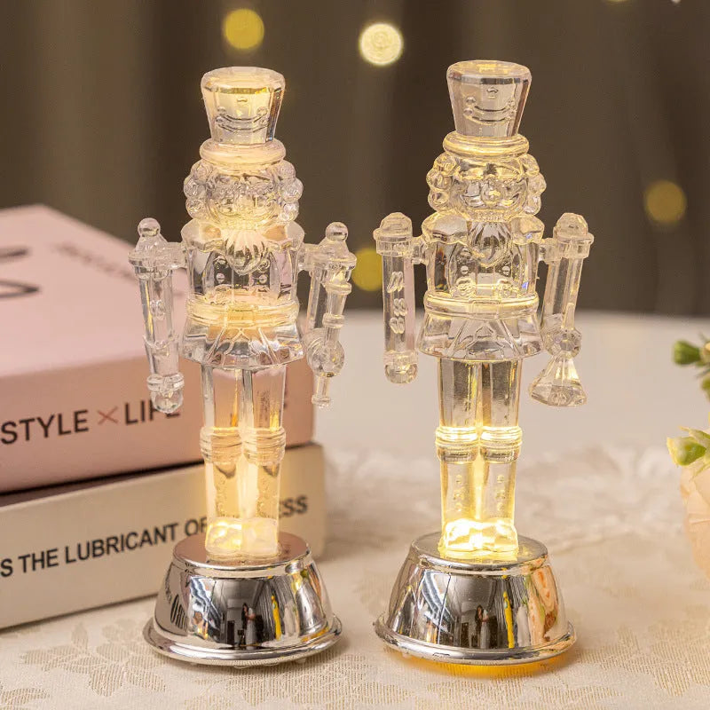 Clear plastic walnut soldier nutcracker Christmas ornament on a desktop