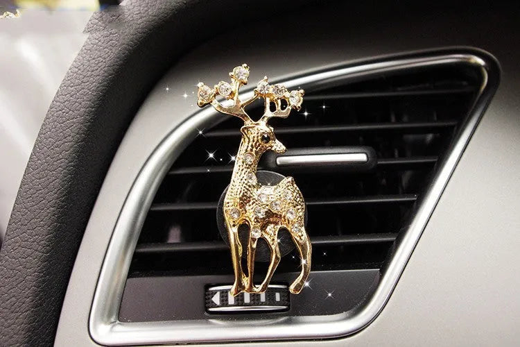 Alloy car fragrance clip with decorative charm attached to car air vent