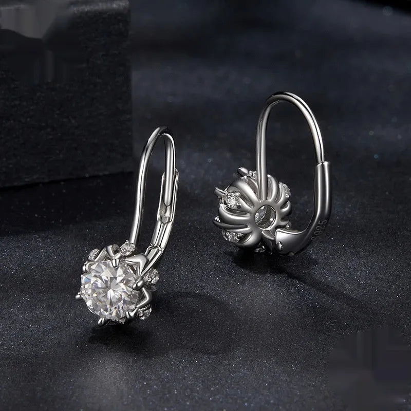 Sterling silver flower bud clip earring with moissanite stone and electroplated platinum finish.