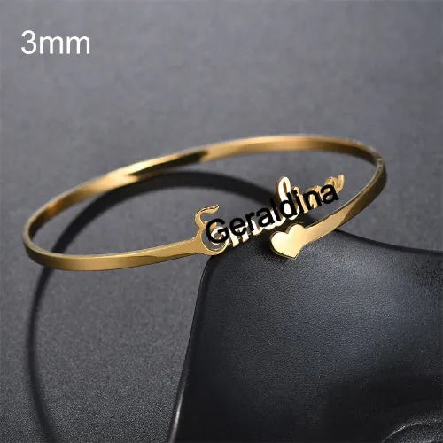 Personalised name bracelet in stainless steel with 10mm width, shown in silver, gold, or rose gold
