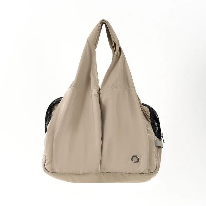 Apricot cloth pet carrier handbag for small dogs or cats, showing handle and breathable fabric.