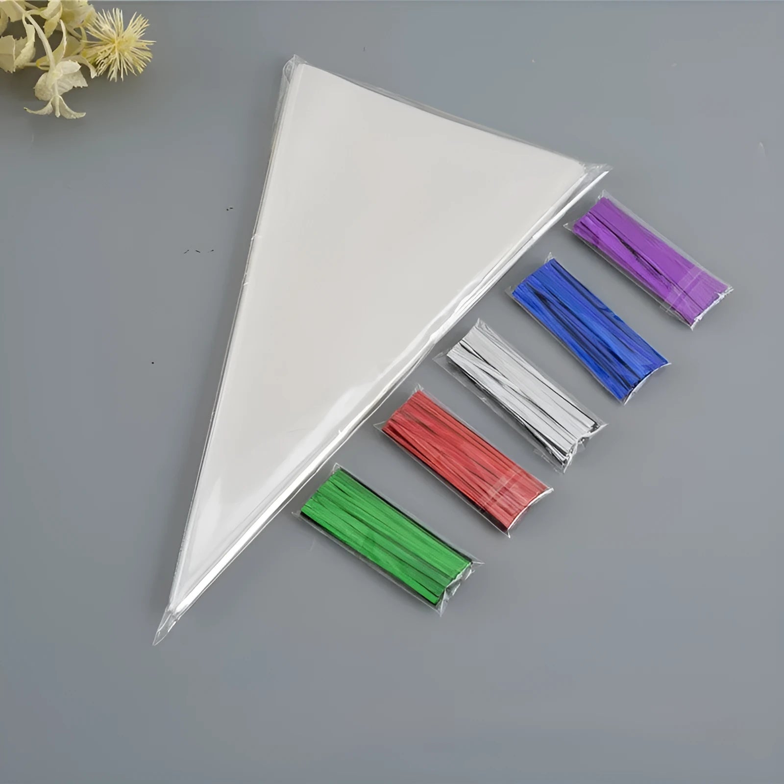 Clear plastic triangle-shaped packaging bag with a silver tie wire closure.