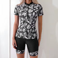 Women's floral print swimsuit with zip front closure and split hem bikini bottoms