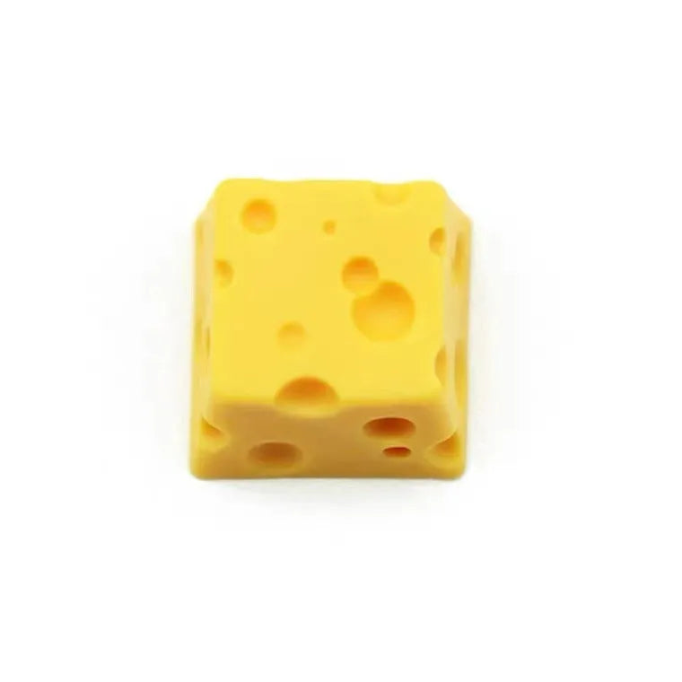 Close-up of a bright yellow resin key cap with a detailed sculpted cheese design.