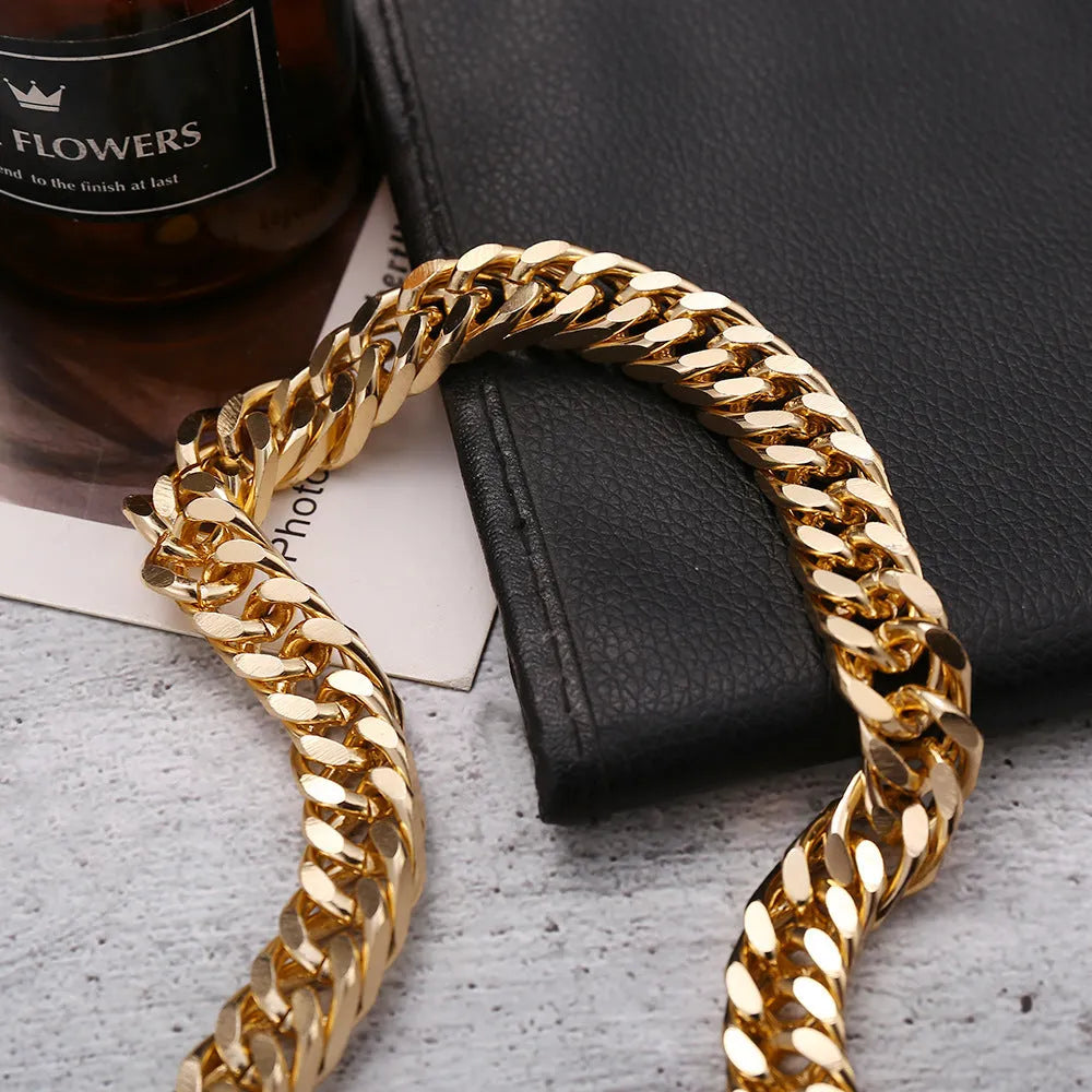 Gold-coloured thick chain necklace for women on a plain background