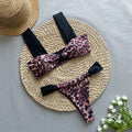 Women's leopard print bikini set with tube top and split bottoms in black and animal print