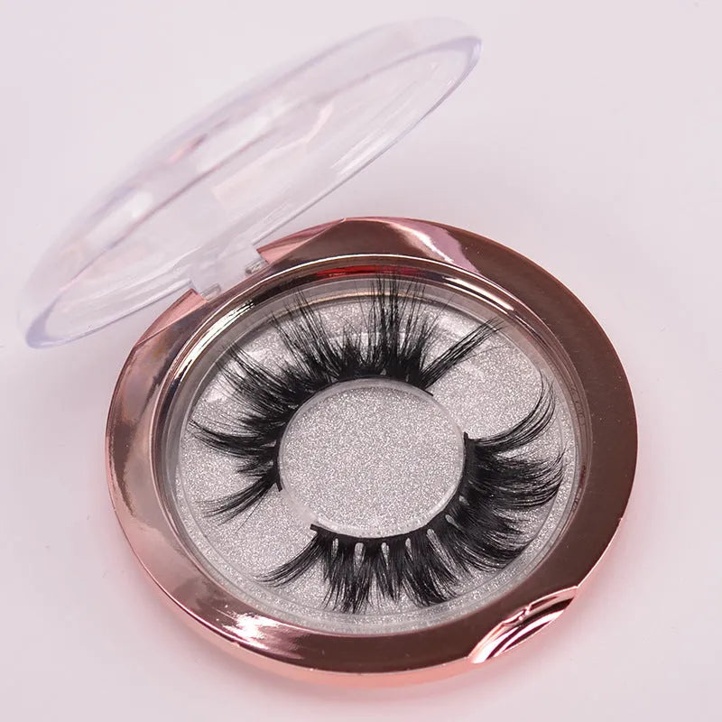 A pair of Affectionate brand 5D false eyelashes made from mink hair, shown with a storage cap and double-headed brush.