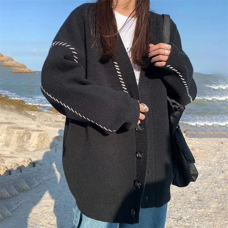 Women's loose fit knitted cardigan coat in black, long sleeve open front design.
