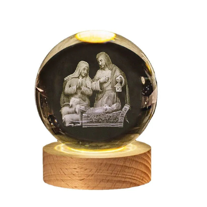 White crystal ball ornament with internal Christian cross figure on a wooden light-up base.