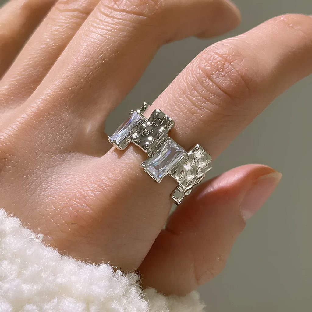 Silver geometric ring with cross zircon detailing and open gemstone setting