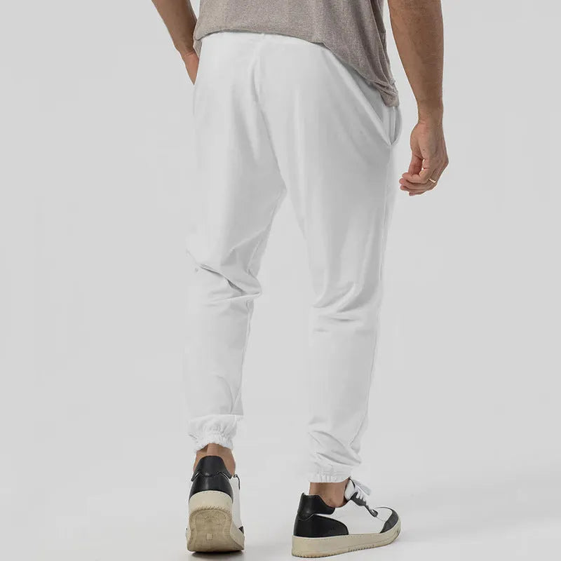 Men's grey casual tapered sweatpants with an elasticated waistband and straight-leg design