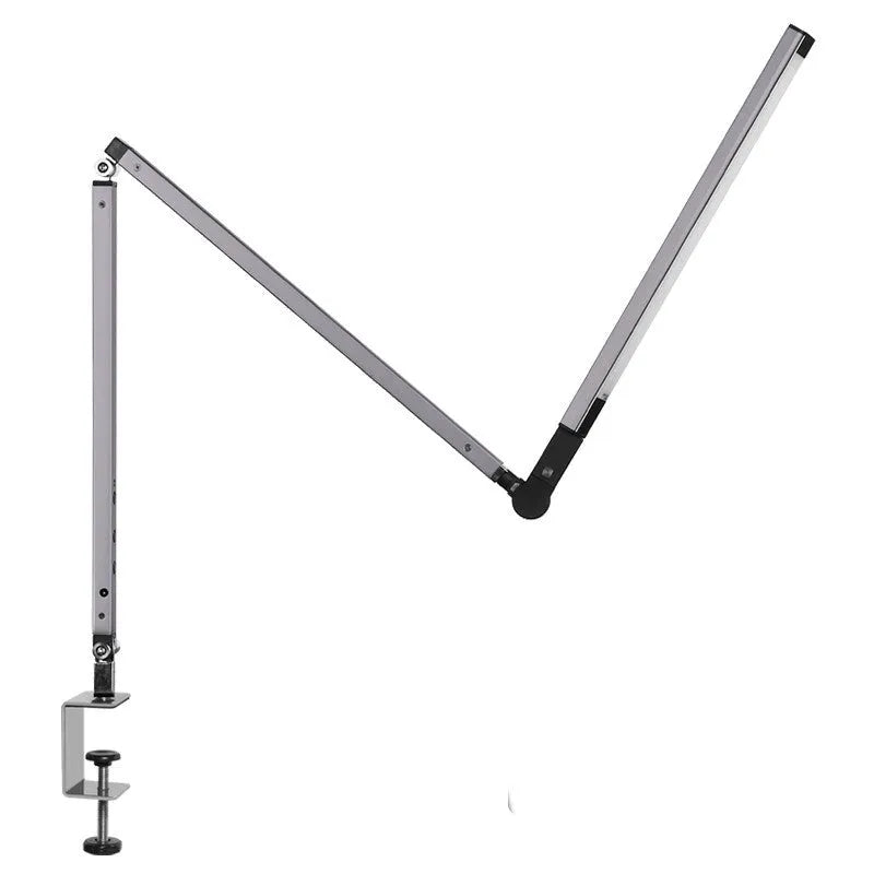 Aluminum clip-on LED desk lamp with dimmer switch mounted on a desk edge.