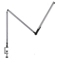 Aluminum clip-on LED desk lamp with dimmer switch mounted on a desk edge.