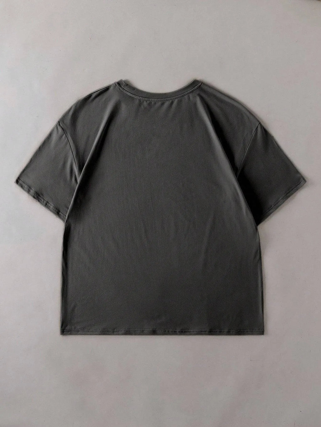 A loose-fitting unisex cotton T-shirt on a hanger, shown in one of its available colours.