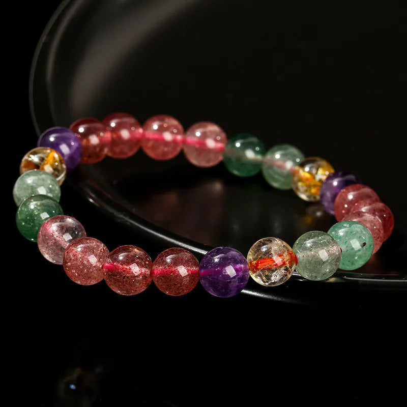 Natural tourmaline colour strawberry quartz bracelet with geometric round beads on a wrist.