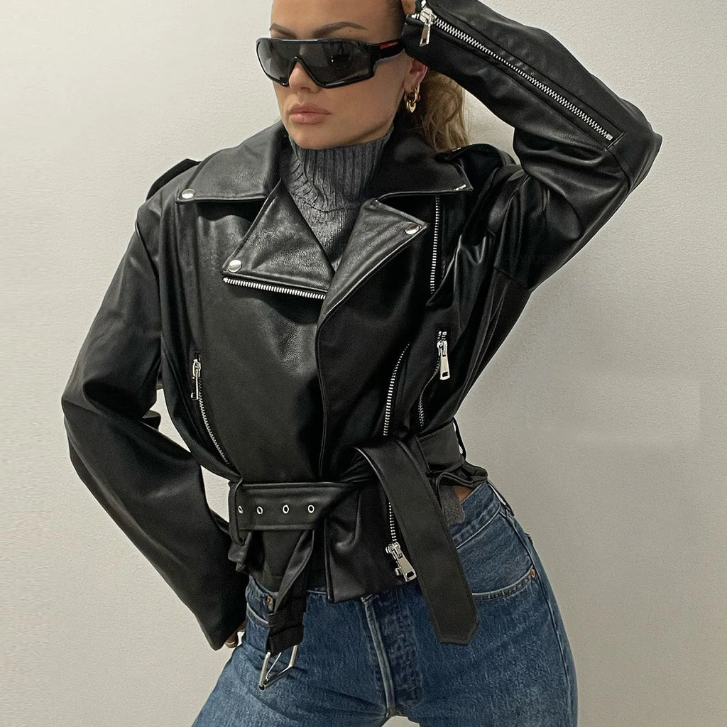 Punk-style short belt lapel jacket in polyester fibre leather, available in black, blue, and green.