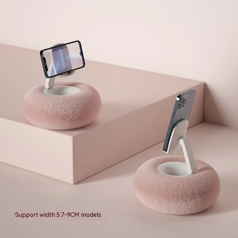 Adjustable rotating bracket holding a tablet, showing vertical extension rod and fabric-covered base.