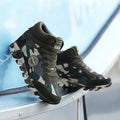 Women's green camouflage canvas sneakers with rubber soles showing slip-on casual style