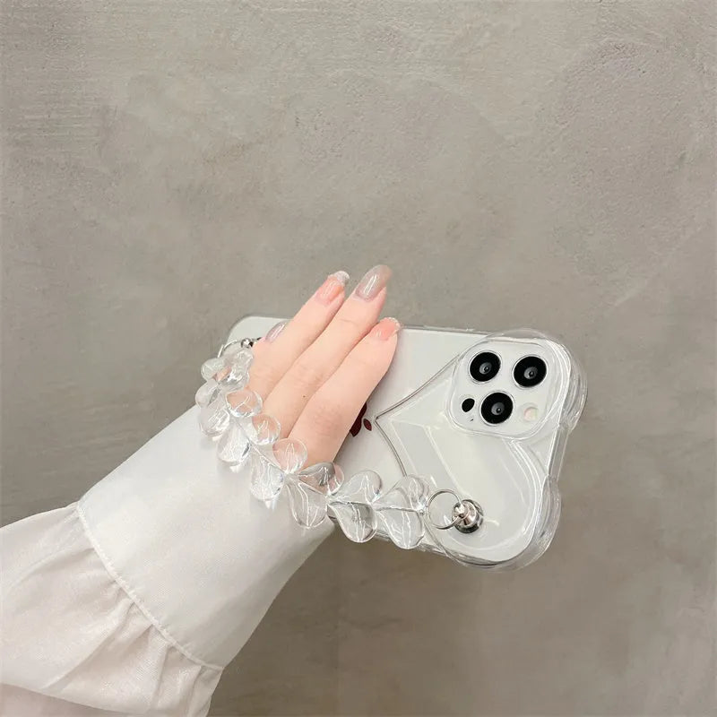 Transparent soft TPU iPhone case with a built-in clear love heart charm and chain.