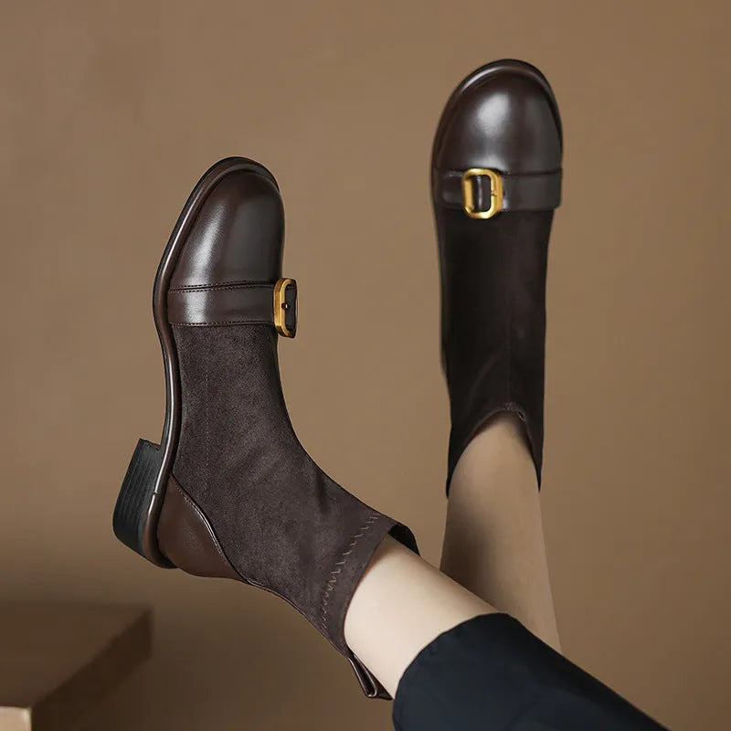 Women's black casual martin boots with belt buckle stitching, lace-up front, and a low rubber sole.