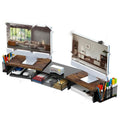 Dual-station desktop monitor rack in wood finish on a desk with laptops