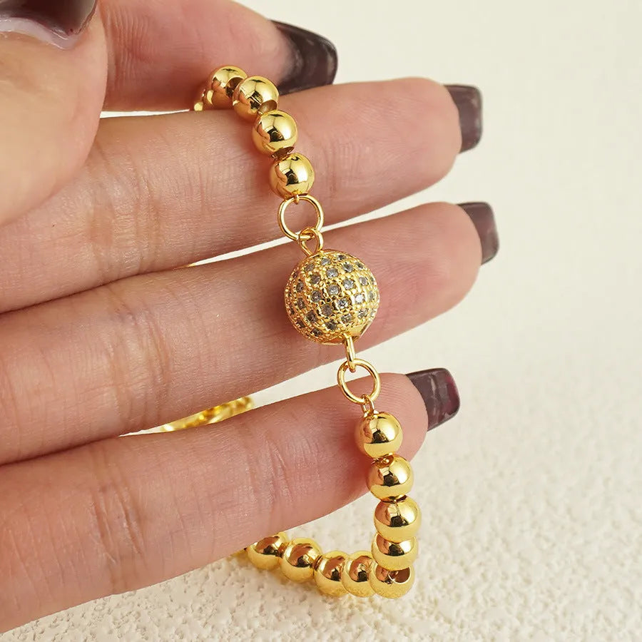 Heart-shaped copper bracelet with round zircon stones in an Arabic style.