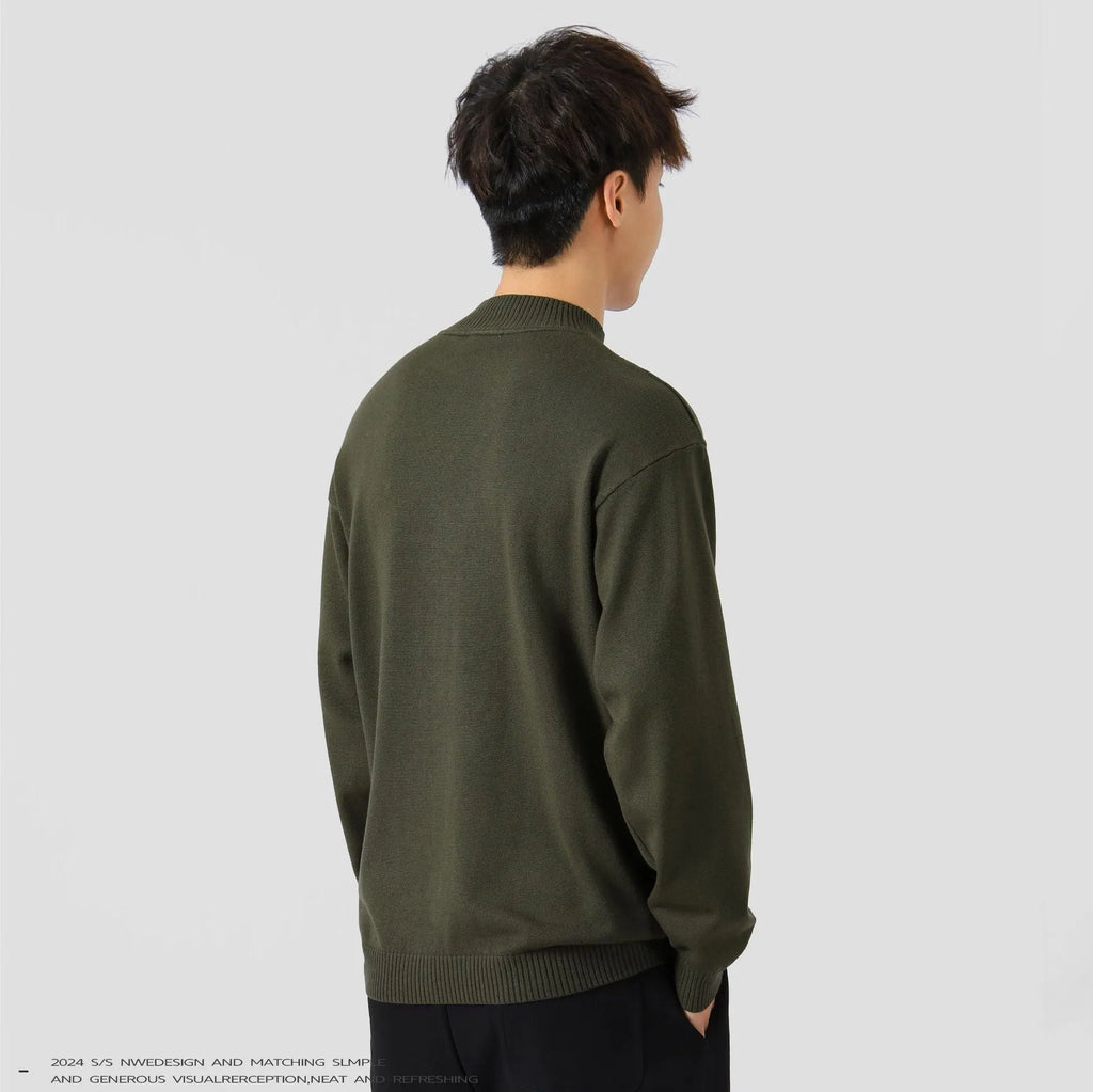 Man wearing a loose-fit army green long sleeve pullover sweater for casual autumn wear.