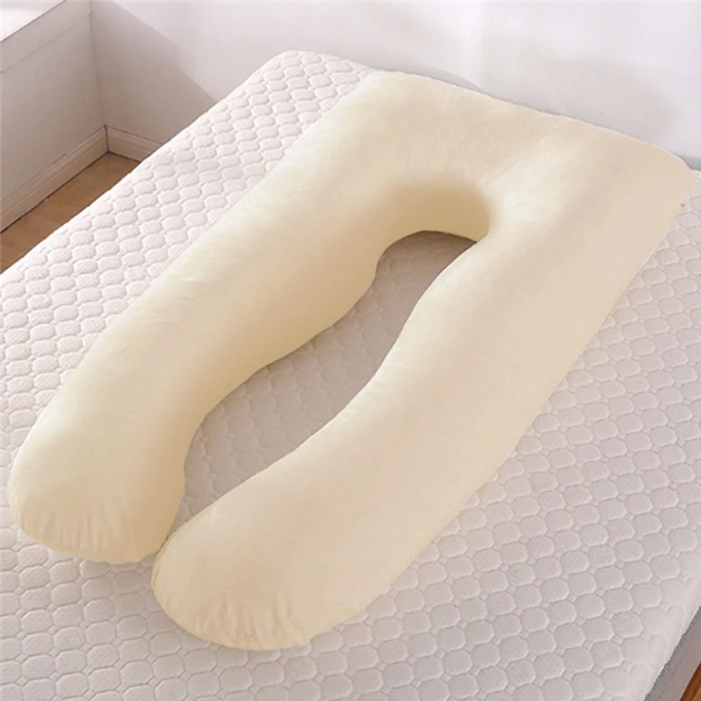 U-shaped white maternity pillow with ice silk cover on a bed, showing its full-body support shape for pregnancy.